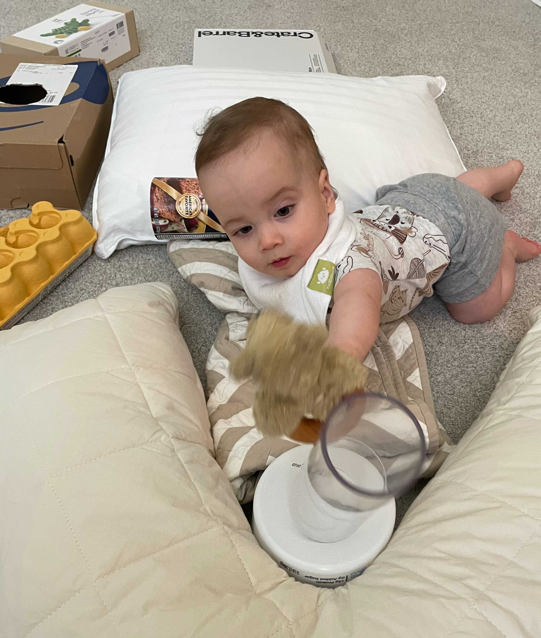 Knocking down a tower surrounded by boxes, pillows, and blankets - learning babies