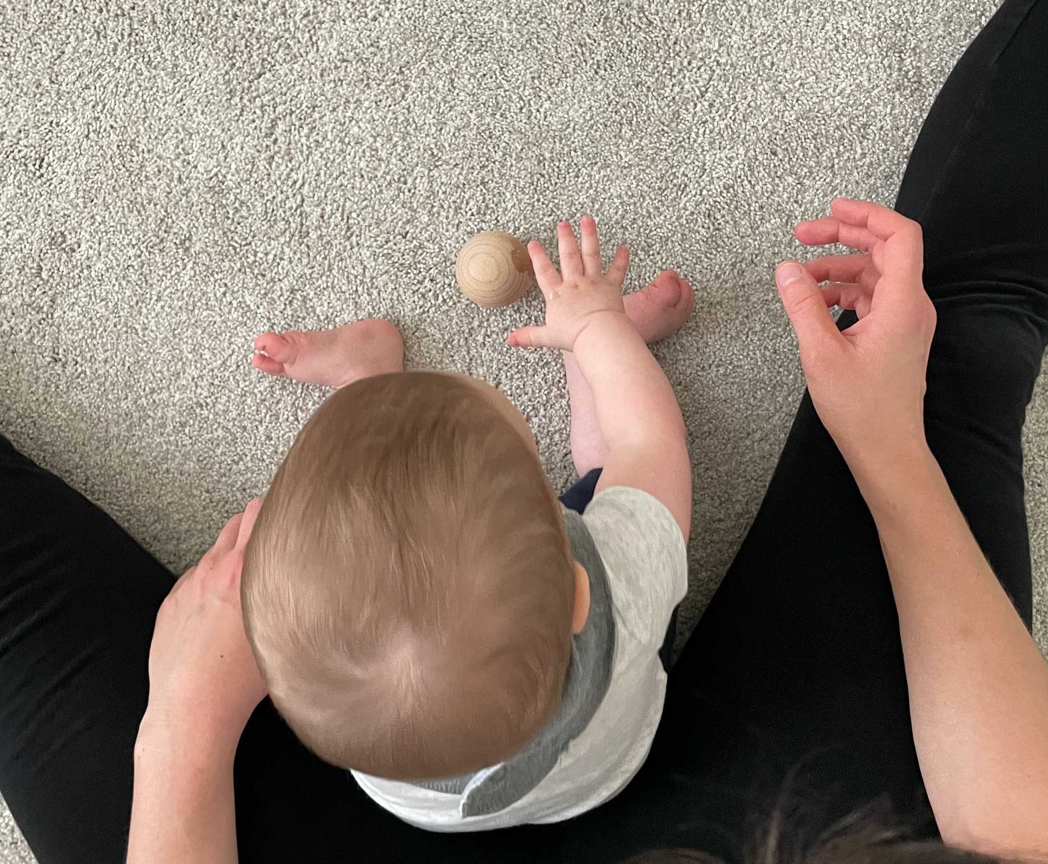 Baby picking up ball