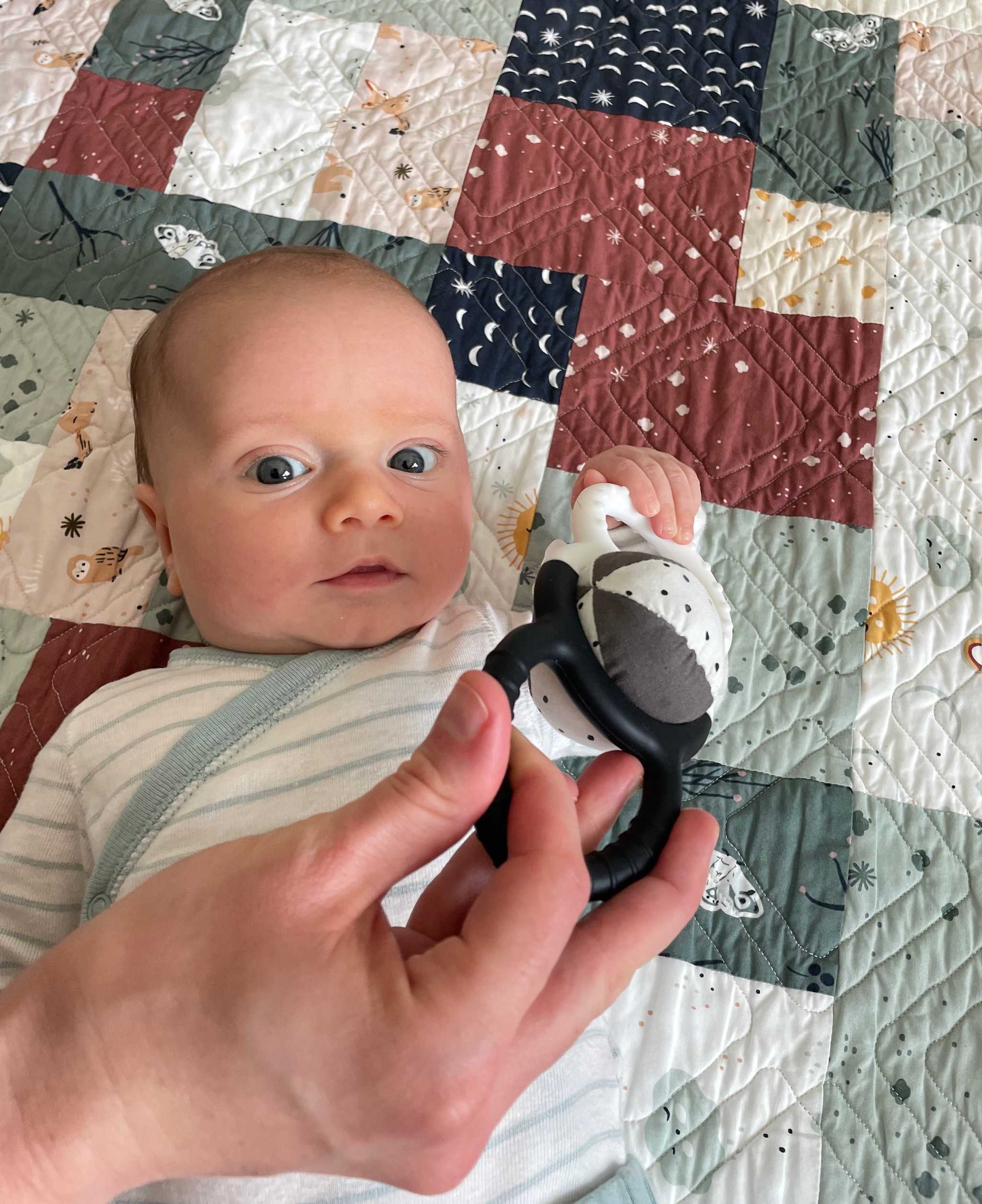 baby holding rattle