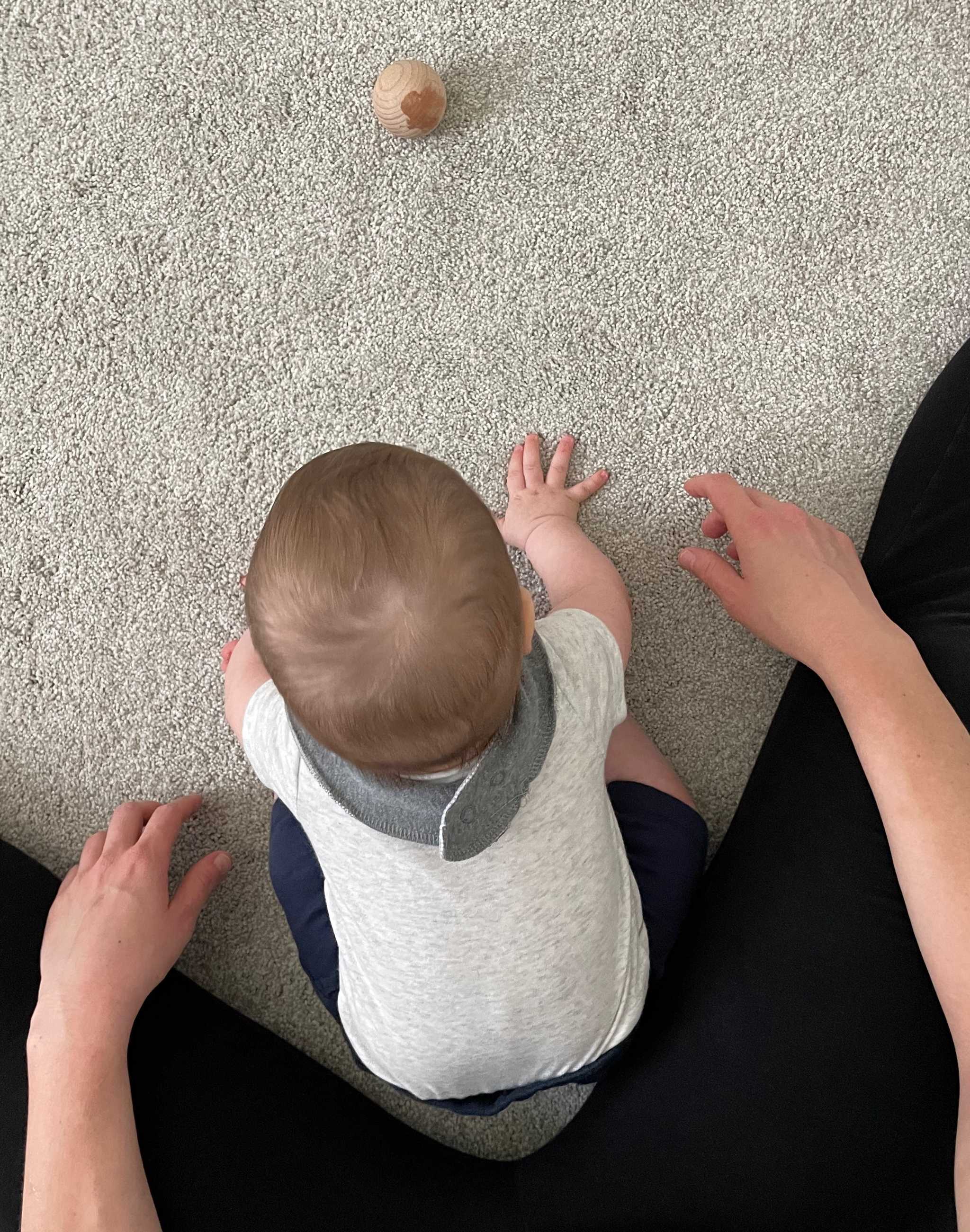 Baby leaning forward from sitting position